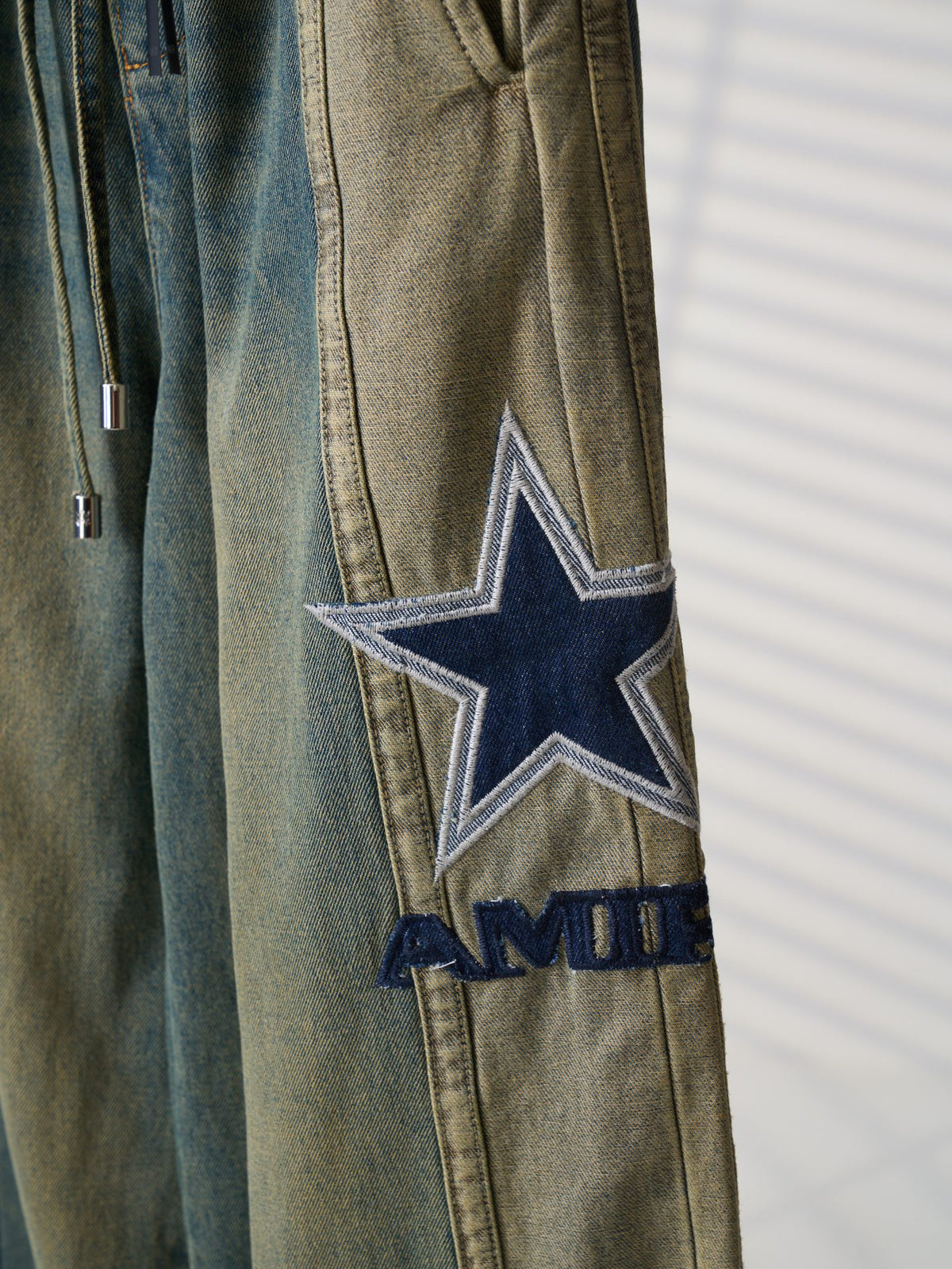 AMIRI Star‑Patch Paneled Drawstring Denim Pants